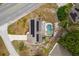 Aerial view showcasing a home with solar panels and a screened-in pool area in a residential neighborhood at 1660 E Apache Cir, Deltona, FL 32725