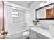 Well-lit bathroom features a shower-tub combo and sleek vanity with modern fixtures and neutral colors at 1660 E Apache Cir, Deltona, FL 32725