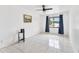 Bright bedroom features large window, tile floors, and ceiling fan at 1660 E Apache Cir, Deltona, FL 32725