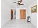 Spacious room with tile floors, ceiling fan, and doors at 1660 E Apache Cir, Deltona, FL 32725