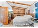 Cozy bedroom boasts a brick fireplace, beamed ceiling, and a view of the ocean at 1660 E Apache Cir, Deltona, FL 32725