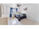 Bedroom with tile floor, ceiling fan, and blue drapes at 1660 E Apache Cir, Deltona, FL 32725