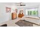 Bright bedroom with tile flooring, ceiling fan, and ample natural light from the window at 1660 E Apache Cir, Deltona, FL 32725