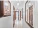 Bright hallway featuring tile floors, framed art, and mirrors creating a spacious feel at 1660 E Apache Cir, Deltona, FL 32725