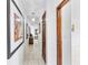 Inviting hallway features tile flooring, artwork, and a decorative pendant light, enhancing the home's appeal at 1660 E Apache Cir, Deltona, FL 32725