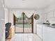 Bright laundry room with a window view of the pool, modern washer/dryer, and storage shelving at 1660 E Apache Cir, Deltona, FL 32725