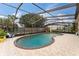 Large swimming pool with covered enclosure surrounded by seating, ideal for relaxing in the sun at 1660 E Apache Cir, Deltona, FL 32725