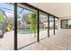 Covered patio area with a large kidney-shaped pool and outdoor seating for relaxation and entertaining at 1660 E Apache Cir, Deltona, FL 32725