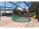 Large kidney-shaped pool with an extended patio area and seating within a screened enclosure at 1660 E Apache Cir, Deltona, FL 32725