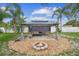 Backyard with a gazebo, furniture, fire pit and landscaping at 1702 Palmetto Ave, Deland, FL 32724