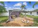 Backyard with a gazebo, furniture, fire pit and landscaping at 1702 Palmetto Ave, Deland, FL 32724