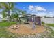 Relaxing backyard with covered seating area, outdoor furniture, and a cozy fire pit on decorative gravel at 1702 Palmetto Ave, Deland, FL 32724
