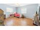 Bright bedroom with a ceiling fan, window, and wood floors at 1702 Palmetto Ave, Deland, FL 32724