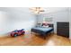 Bright bedroom with a ceiling fan, window, wood floors and furniture at 1702 Palmetto Ave, Deland, FL 32724