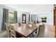 Dining room with an expansive wood table, natural light, and direct access to other living areas at 1702 Palmetto Ave, Deland, FL 32724