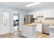 Well-lit kitchen featuring stainless steel appliances, a functional island, and clean, bright interiors at 1702 Palmetto Ave, Deland, FL 32724