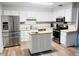 Well-lit kitchen featuring stainless steel appliances and a center island with butcher block countertop at 1702 Palmetto Ave, Deland, FL 32724