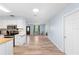 Open-concept living area with wood flooring and an abundance of natural light at 1702 Palmetto Ave, Deland, FL 32724