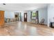 Bright living room featuring wood floors, ample space, and large windows with pleasant natural light at 1702 Palmetto Ave, Deland, FL 32724