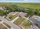 Aerial view of a single-Gathering home with a long driveway and fenced backyard surrounded by lush trees at 1846 N Acadian Dr, Deltona, FL 32725