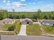 Aerial view of home showcasing the house, driveway, neighboring houses, and surrounding lush greenery at 1846 N Acadian Dr, Deltona, FL 32725