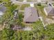 An aerial view of a fenced property with an extended back porch and mature trees at 1846 N Acadian Dr, Deltona, FL 32725