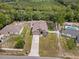 Aerial view of home showcasing the house, driveway, neighboring houses with pools, and wooded surroundings at 1846 N Acadian Dr, Deltona, FL 32725