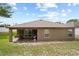 Exterior back of home featuring a covered patio and a window with a view of the backyard at 1846 N Acadian Dr, Deltona, FL 32725