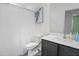 Well-lit bathroom featuring white vanity, coordinating grey cabinets and a shower with curtain at 1846 N Acadian Dr, Deltona, FL 32725