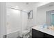 Bathroom featuring sleek vanity, white shower curtain, and stylish mirror at 1846 N Acadian Dr, Deltona, FL 32725