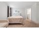 Well-lit bedroom featuring neutral carpet and a bed with patterned sheets and a tan blanket at 1846 N Acadian Dr, Deltona, FL 32725