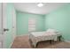 Cozy bedroom painted in a light green with carpet and window at 1846 N Acadian Dr, Deltona, FL 32725