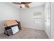 Bright bedroom featuring neutral carpet, a ceiling fan, and natural light from the window at 1846 N Acadian Dr, Deltona, FL 32725