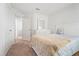 Relaxing bedroom with neutral carpet and a bed with patterned sheets and a tan blanket at 1846 N Acadian Dr, Deltona, FL 32725
