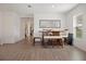 Bright dining area featuring wood-look floors, a modern dining table, and ample natural light at 1846 N Acadian Dr, Deltona, FL 32725