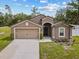 Charming single-story home featuring a two-car garage, well-manicured lawn, and a stylish front entrance at 1846 N Acadian Dr, Deltona, FL 32725