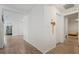 Hallway with wood floors, white walls, and multiple doorways at 1846 N Acadian Dr, Deltona, FL 32725