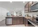 Spacious kitchen with granite countertops, stainless appliances, and an open view to the living area at 1846 N Acadian Dr, Deltona, FL 32725