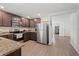 Modern kitchen with stainless steel appliances, granite countertops, and dark wood cabinets at 1846 N Acadian Dr, Deltona, FL 32725