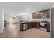 Open kitchen overlooking the living area, featuring stainless steel appliances and dark wood cabinetry at 1846 N Acadian Dr, Deltona, FL 32725