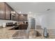 Well-equipped kitchen featuring granite counters, stainless appliances and dark cabinets at 1846 N Acadian Dr, Deltona, FL 32725