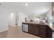 Kitchen featuring a breakfast bar with granite countertops and stainless steel appliances open to living area at 1846 N Acadian Dr, Deltona, FL 32725