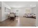 Open-concept living and dining area with wood-look floors and a comfortable beige sofa at 1846 N Acadian Dr, Deltona, FL 32725