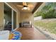 Inviting covered patio area with ceiling fan, outdoor seating, and a colorful mosaic table at 1846 N Acadian Dr, Deltona, FL 32725