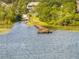Picturesque lake view featuring a wooden dock and vibrant foliage from above at 19232 Park Place Blvd, Eustis, FL 32736