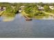Overhead shot of a lake with a wooden dock and lush greenery along the shoreline at 19232 Park Place Blvd, Eustis, FL 32736