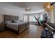 Bright bedroom with a large window, exercise equipment, and sleek laminate flooring at 19232 Park Place Blvd, Eustis, FL 32736