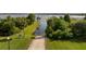 Aerial shot of a boat ramp leading to a picturesque lake, framed by vibrant green foliage and clear blue skies at 19232 Park Place Blvd, Eustis, FL 32736