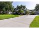 Charming single-story home with well-manicured lawn and long concrete driveway at 19232 Park Place Blvd, Eustis, FL 32736