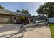 Home exterior featuring an attached garage, driveway with trailer, and a well-maintained lawn at 19232 Park Place Blvd, Eustis, FL 32736